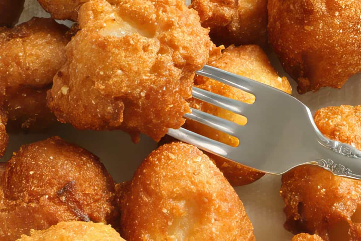 These beauties are crispy on the outside and fluffy on the inside. A real treat. Garlic and Onion Hush Puppy Recipe 2 cups cornmeal 2 TBS flour 1 tsp baking soda 1 tsp baking powder 1 tsp kosher salt 1/2 tsp garlic powder 1/2 cup finely chopped sweet onion 1/4 cup finely chopped green onion tops 1 egg yolk 1 cup buttermilk 8 egg whites oil for frying Mix the first six ingredients together. Add the sweet and green onion. Mix the egg yolk and the buttermilk together and add to the mixture. Heat enough oil in a pan to cover teaspoon-full sized hush puppy mixture. Whip the egg whites until it forms stiff peaks and fold into the mixture. Drop batter into hot oil and fry until golden brown. Drain on paper towel or a paper bag.